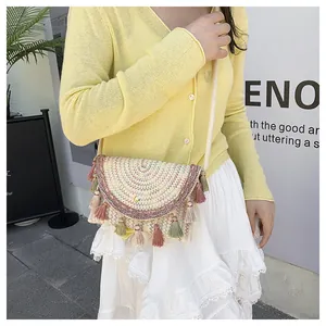 Outdoor lifestyle shot of a woven saddle bag with colorful tassels and embroidery details