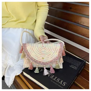 Detail of hand-woven saddle bag featuring colorful fringe and ethnic wave patterns