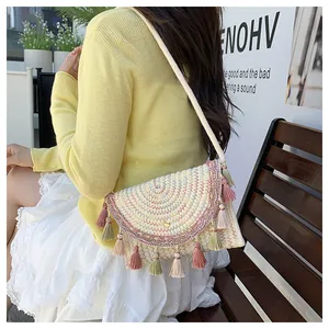 Detail of woven saddle bag with colorful embroidery and tassels for boho style