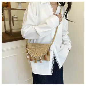 Close-up of woven saddle bag with fringe tassels and gold patterned trim detail