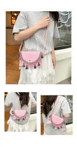 Detailed view of pink woven saddle bag with colorful tassels and scalloped lace trim