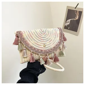 Detail of bohemian woven saddle bag with colorful embroidery and elegant tassels