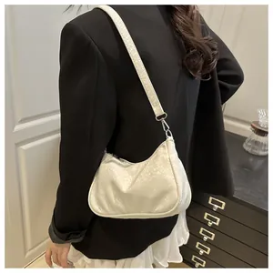 Detail of white faux snake pattern underarm bag with silver hardware and zipper