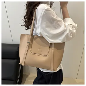 Detail of adjustable metal buckle on a large beige leather tote bag for women