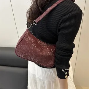 Fashionable burgundy snake pattern shoulder bag with silver hardware and top zipper closure