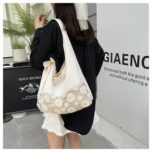 Detail of canvas tote bag featuring floral lace crochet bottom and ribbon bow decoration