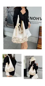 Close-up of beige canvas tote bag with floral lace crochet detail and ribbon bow