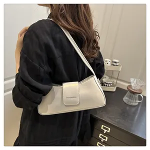 Detailed view of glossy patent leather shoulder bag showing the fine texture and flap design