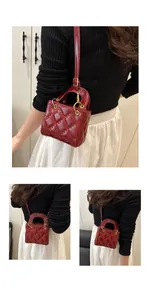 Detail of red quilted patent leather handbag with gold circular handles and shoulder strap