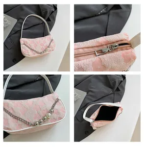 Detail view of pink floral jacquard shoulder bag with pearl chain and metal zipper