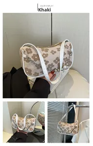 Close-up of khaki floral print shoulder bag with white strap and pearl chain detail