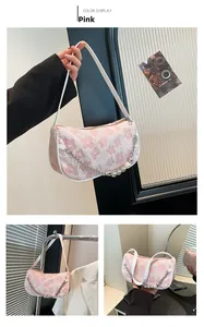 Detail of pink floral jacquard shoulder bag with pearl beads and silver chain decoration