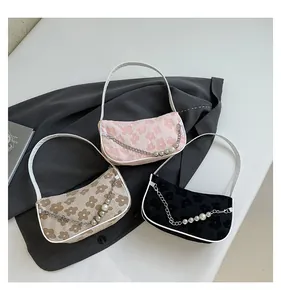 Detail of floral jacquard shoulder bags in pink, khaki, and black with pearl chain decor