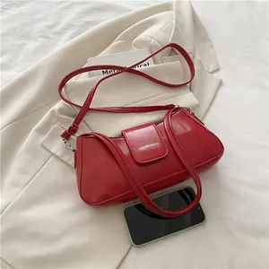 Fashionable red patent leather underarm shoulder bag with adjustable strap and top handle