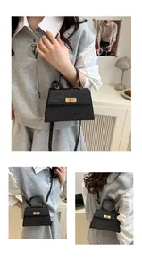 Close-up of black glitter crossbody bag with gold turn-lock and removable strap