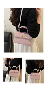 Detail of pink glitter handbag featuring a trapezoid shape and gold twist lock closure