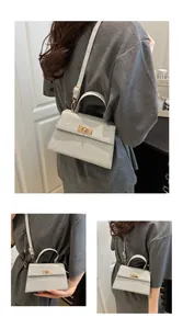 Close-up of a silver glitter handbag with a gold twist lock and adjustable strap