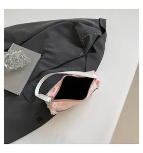 Pink woven jacquard shoulder bag featuring white leather straps and silver metal hardware