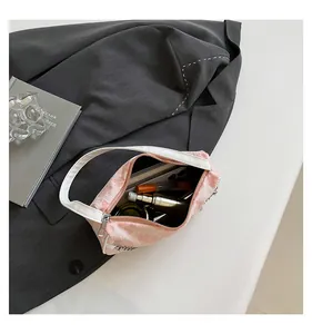 Top view of pink textured floral mini bag showing interior space for phone and makeup