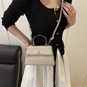 Sparkling champagne gold sequin handbag with gold twist lock and crossbody strap