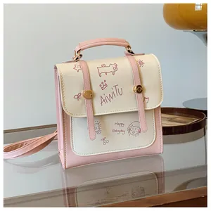 Dettaglio della borsa a tracolla rosa e bianca con motivi scarabocchio e chiusura a girello