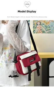 Detail of red and white messenger bag with plastic buckles and plush octopus charm