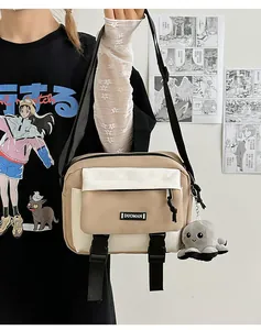 Detail of canvas crossbody bag with contrast stitching and plush octopus charm accessory