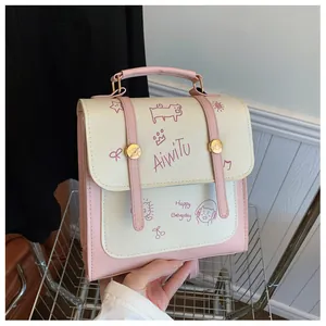 Dettaglio dello zaino in ecopelle rosa e beige con stampe a fumetti e manico superiore