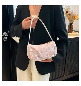Detail of pink floral woven shoulder bag with pearl chain strap and texture
