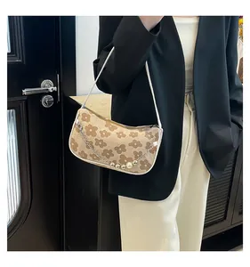 Detail of floral woven shoulder bag with pearl chain strap and crescent shape design