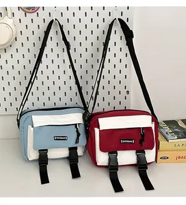 Detail of color-block crossbody bags with dual buckles and adjustable black straps