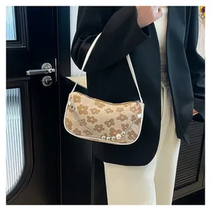 Women's floral knit underarm bag with cream base, brown flowers and pearl chain detail