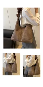 Close-up of a large vintage brown tote bag with stone-wash texture and wide shoulder strap