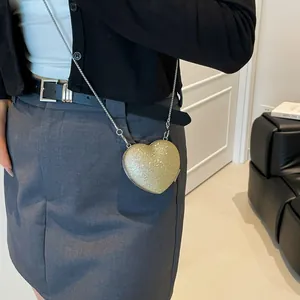 Gold glitter heart-shaped mini crossbody bag with a delicate silver chain strap for women