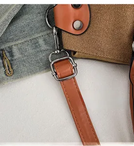 Detail of durable gunmetal hardware hooks on vintage canvas tote bag with leather strap