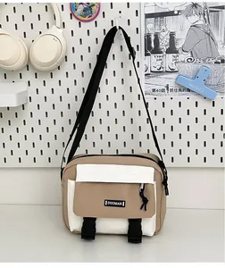 Detail of khaki and white canvas messenger bag with adjustable strap and buckles