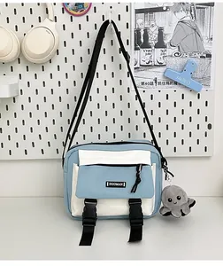 Detail of the blue and white canvas messenger bag with a black buckle and octopus plush