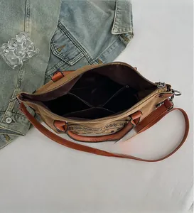 Detail view of khaki canvas tote bag interior with multiple compartments and zippers