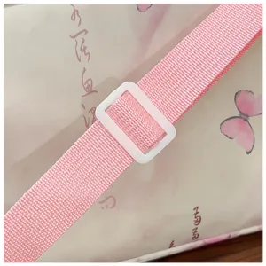 Close-up of pink crossbody bag nylon strap with white plastic adjustable buckle