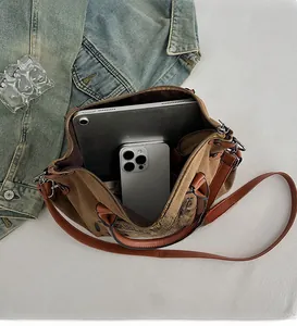 Interior view showing the large capacity of the vintage canvas bag with a tablet