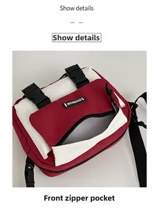 Detailed view of the red and white crossbody bag featuring a secure front zipper pocket