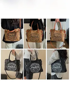 Detail view of large canvas tote bag showing retro PARIS logo and adjustable strap