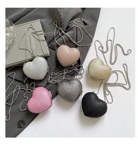 Detail view of heart-shaped glitter evening bags with chain straps in six shiny colors