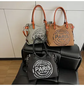 Detailed trio of vintage canvas tote bags in gray, brown, and black with Paris printing
