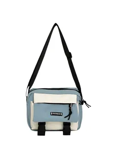 Detail of canvas crossbody bag showing blue-white contrast and front zipper pocket