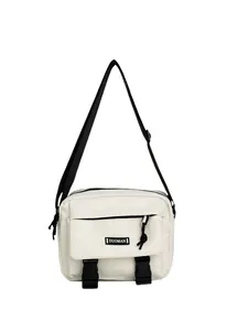 Detailed close-up of cream messenger bag showing buckle straps and DUOMAN brand logo