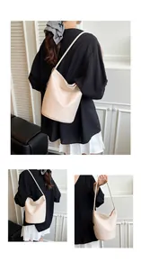 Detailed view of cream-white bucket bag with lychee grain leather and silver metal chain