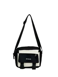 Close-up of black and white contrast messenger bag with buckle and adjustable strap
