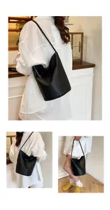 Detailed view of black lychee grain leather bucket bag with silver chain accessory