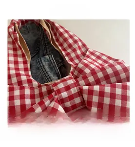 Close-up of red and white gingham pattern fabric and large bow detail on a tote bag
